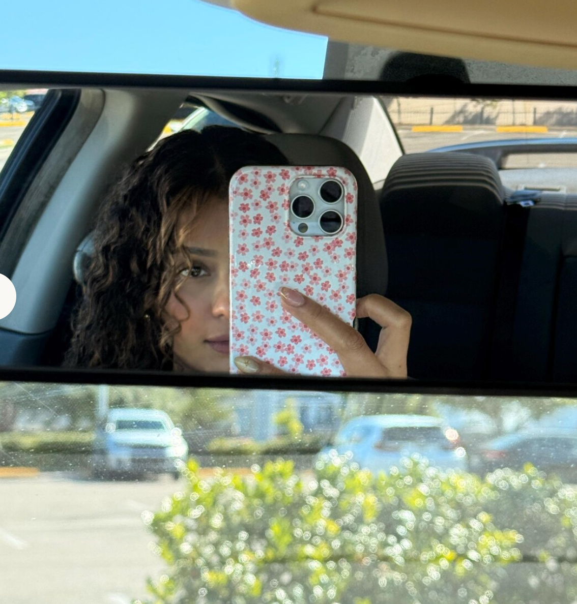 Community mirror photo with a floral phone case